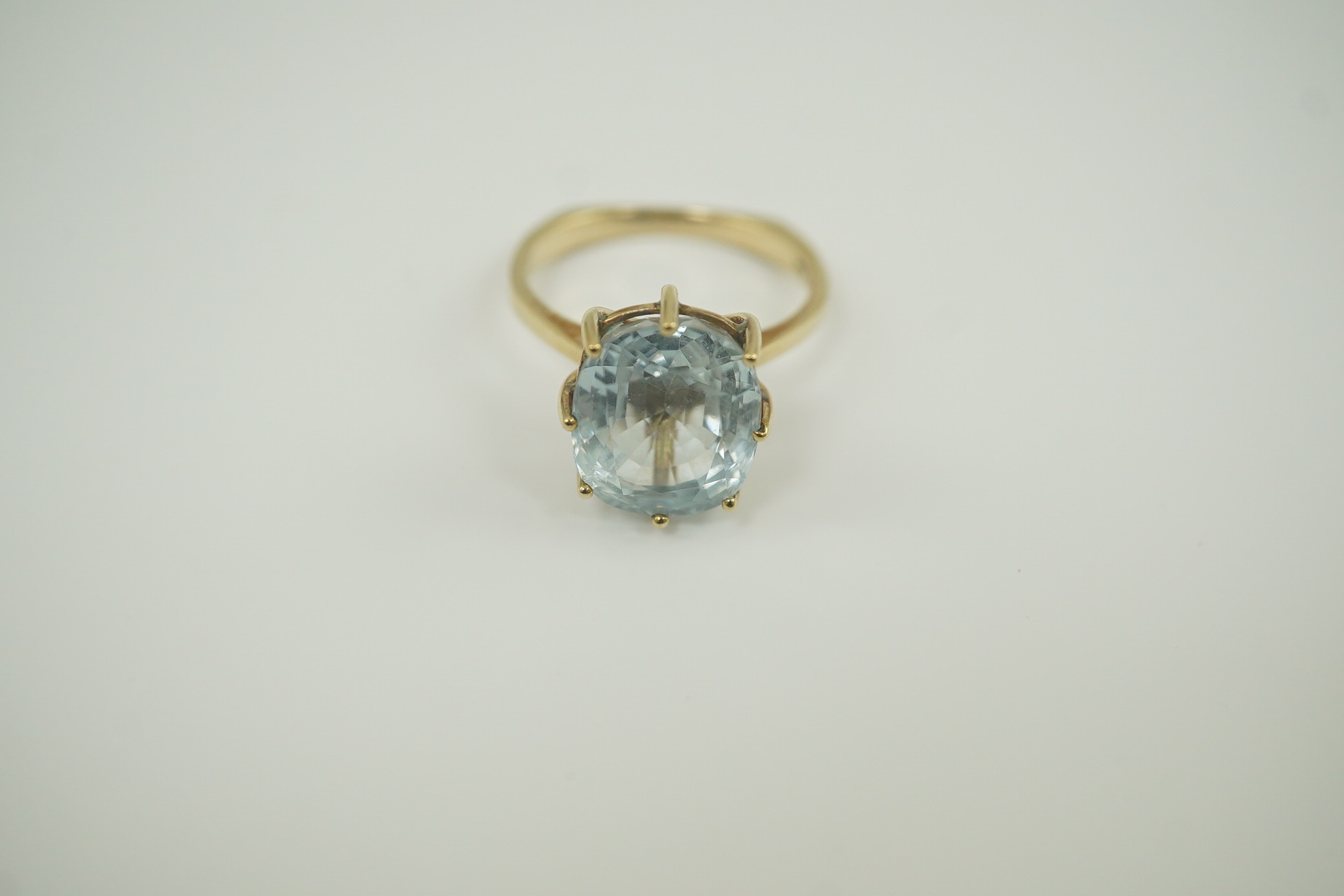 A 1970's 9ct gold and single stone oval cut aquamarine set dress ring